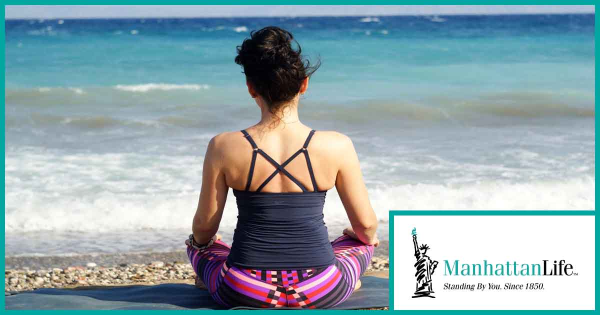 women meditating by the ocean