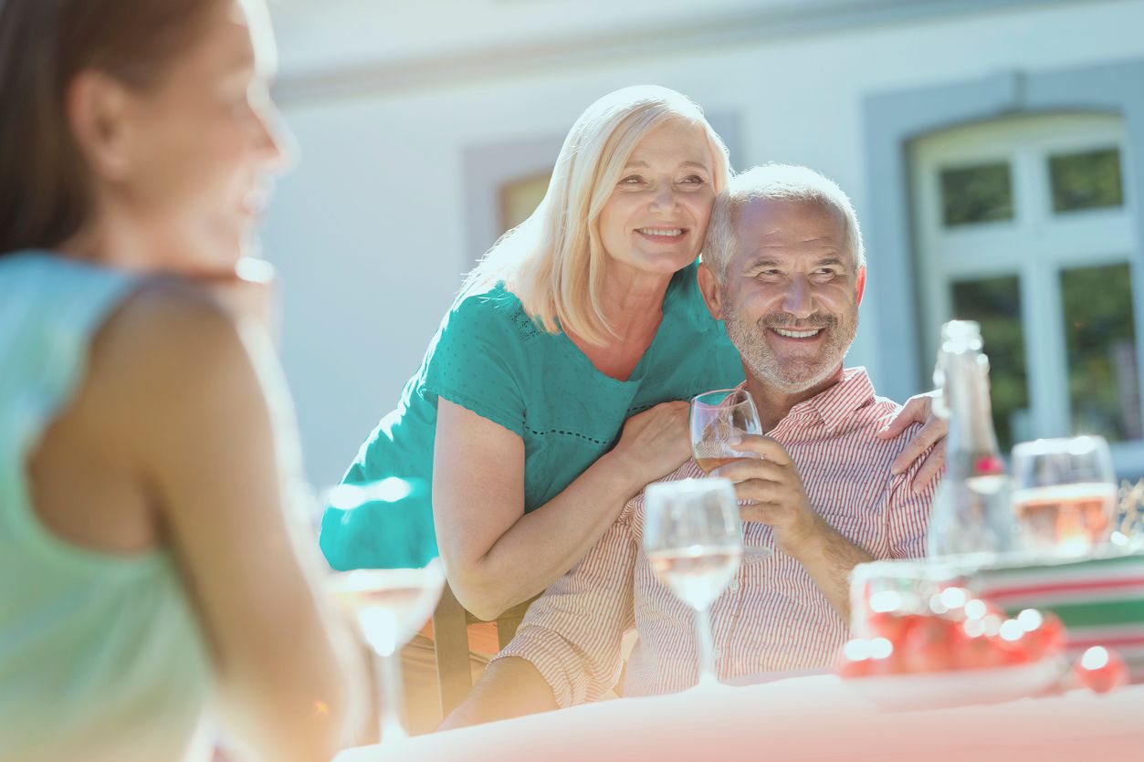 Senior couple sitting outdoors and smiling